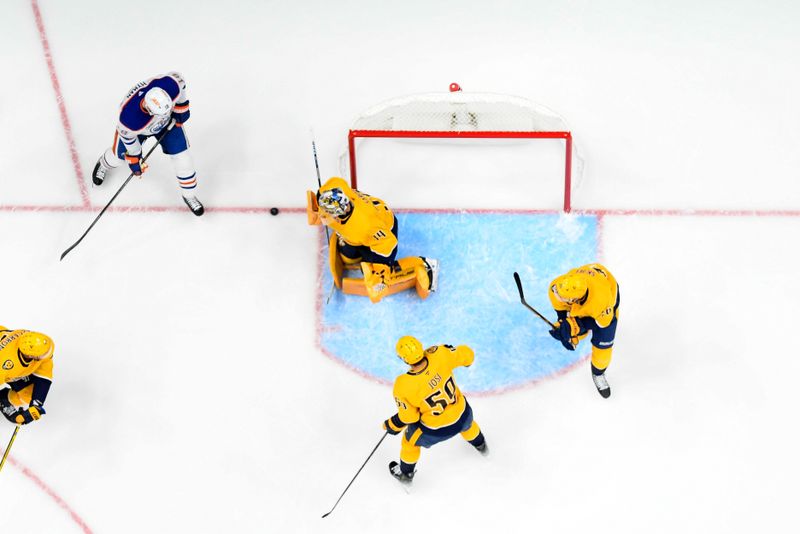 Oct 31, 2024; Nashville, Tennessee, USA;   Nashville Predators goaltender Juuse Saros (74) blocks the shot of Edmonton Oilers left wing Zach Hyman (18) during the first period at Bridgestone Arena. Mandatory Credit: Steve Roberts-Imagn Images