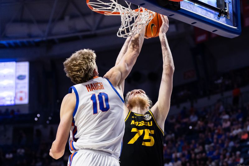 Feb 28, 2024; Gainesville, Florida, USA; Missouri Tigers center Connor Vanover (75) dunks the ball over Florida Gators forward Thomas Haugh (10) during the first half at Exactech Arena at the Stephen C. O'Connell Center. Mandatory Credit: Matt Pendleton-USA TODAY Sports