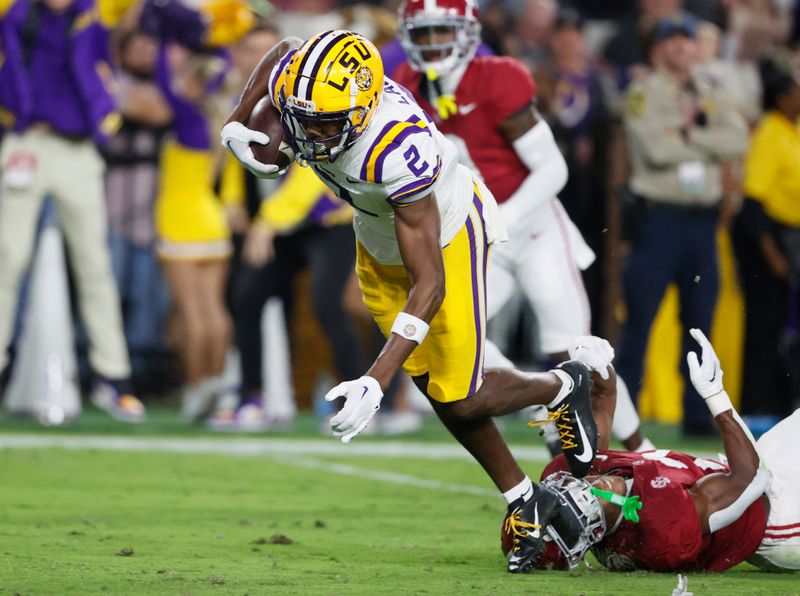 Nov 4, 2023; Tuscaloosa, Alabama, USA; LSU Tigers wide receiver Kyren Lacy (2) catches a pass and carries the ball in for a touchdown as Alabama Crimson Tide defensive back Caleb Downs (2) defends during the first half at Bryant-Denny Stadium. Mandatory Credit: Butch Dill-USA TODAY Sports