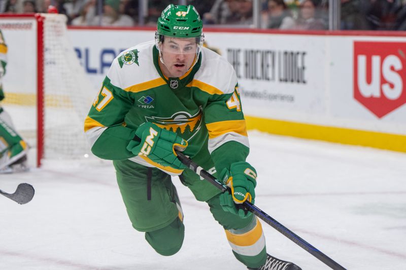 Dec 31, 2024; Saint Paul, Minnesota, USA; Minnesota Wild defenseman Declan Chisholm (47) plays the puck after a face off against the Nashville Predators in the third period at Xcel Energy Center. Mandatory Credit: Matt Blewett-Imagn Images