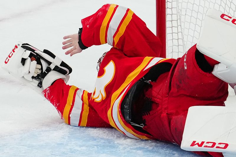 Jan 13, 2024; Las Vegas, Nevada, USA; Calgary Flames goaltender Jacob Markstrom (25) defends his net against the Vegas Golden Knights after losing his catching glove during the third period at T-Mobile Arena. Mandatory Credit: Stephen R. Sylvanie-USA TODAY Sports