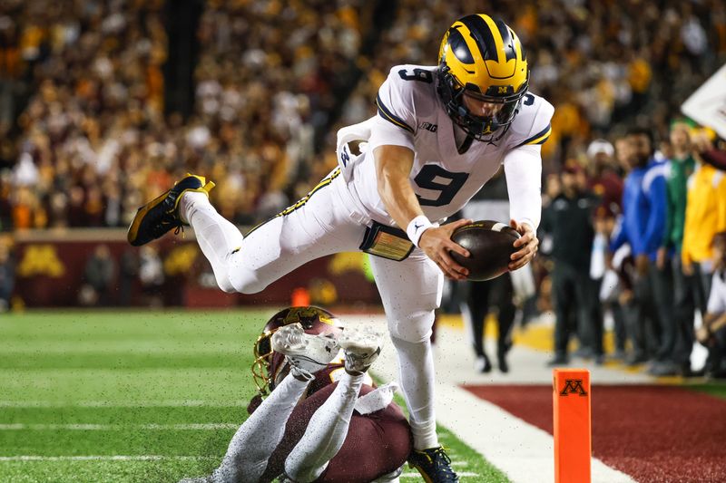 Oct 7, 2023; Minneapolis, Minnesota, USA; Michigan Wolverines quarterback J.J. McCarthy (9) dives for a  touchdown against the Minnesota Golden Gophers during the second quarter at Huntington Bank Stadium. Mandatory Credit: Matt Krohn-USA TODAY Sports