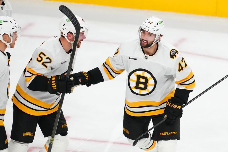 Oct 16, 2025; Las Vegas, Nevada, USA; Boston Bruins center Mark Kastelic (47) celebrates with forward Sean Kuraly (52) after scoring a goal against the Vegas Golden Knights during the third period at T-Mobile Arena. Mandatory Credit: Stephen R. Sylvanie-Imagn Images
