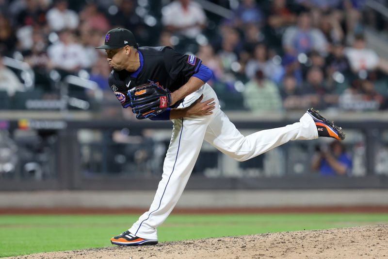 May 24, 2024; New York City, New York, USA; New York Mets relief pitcher Edwin Diaz (39) follows through on a pitch against the San Francisco Giants during the seventh inning at Citi Field. Mandatory Credit: Brad Penner-USA TODAY Sports