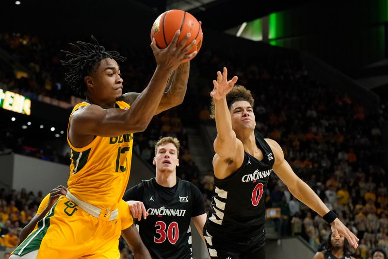 Jan 13, 2024; Waco, Texas, USA; Baylor Bears guard Langston Love (13) grabs the rebound in front of Cincinnati Bearcats guard Dan Skillings Jr. (0) during the first half at Paul and Alejandra Foster Pavilion. Mandatory Credit: Raymond Carlin III-USA TODAY Sports