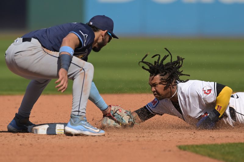 Sep 15, 2024; Cleveland, Ohio, USA; Tampa Bay Rays shortstop Jose Caballero (7) tags out Cleveland Guardians designated hitter Jose Ramirez (11) while stealing during the fifth inning at Progressive Field. Mandatory Credit: Ken Blaze-Imagn Images