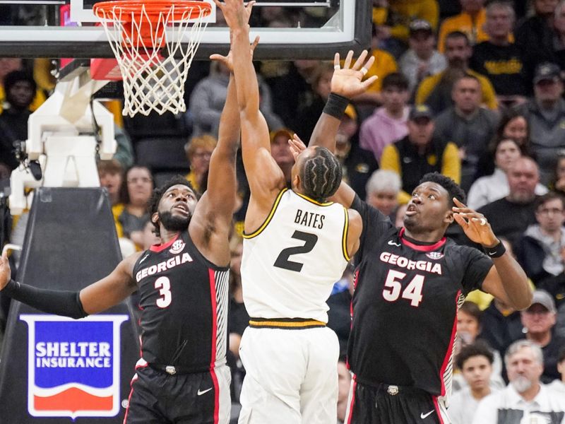 Jan 6, 2024; Columbia, Missouri, USA; Missouri Tigers guard Tamar Bates (2) shoots as Georgia Bulldogs guard Noah Thomasson (3) and center Russel Tchewa (54) defend during the second half at Mizzou Arena. Mandatory Credit: Denny Medley-USA TODAY Sports