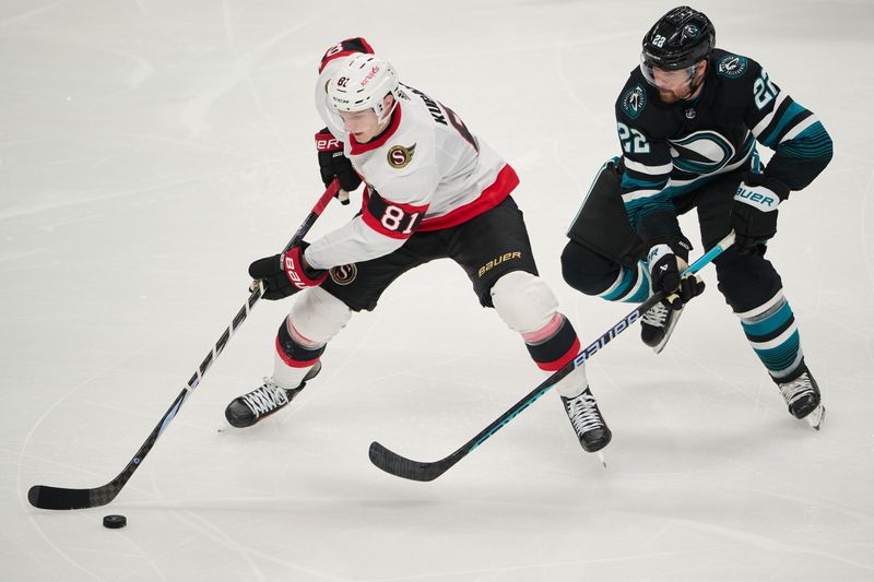 Mar 9, 2024; San Jose, California, USA; Ottawa Senators left wing Dominik Kubalik (81) plays the puck against San Jose Sharks center Ryan Carpenter (22) during the third period at SAP Center at San Jose. Mandatory Credit: Robert Edwards-USA TODAY Sports