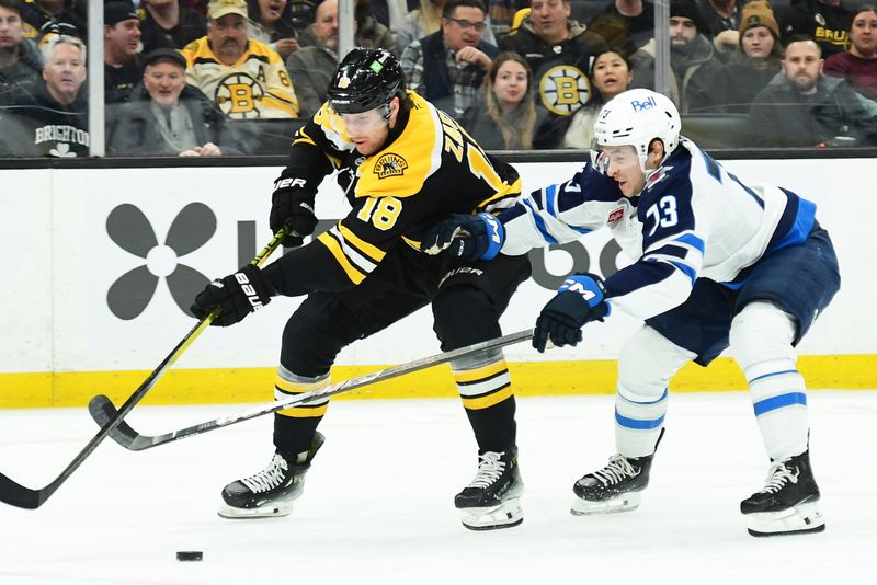 Jan 30, 2025; Boston, Massachusetts, USA;  Boston Bruins center Pavel Zacha (18) skates in on goal while Winnipeg Jets center Parker Ford (73) defends during the first period at TD Garden. Mandatory Credit: Bob DeChiara-Imagn Images
