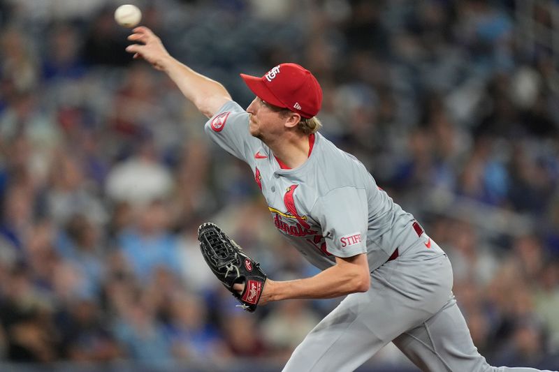 Sep 13, 2024; Toronto, Ontario, CAN; St. Louis Cardinals pitcher Erick Fedde (12) pitches to the Toronto Blue Jays  during the fourth inning at Rogers Centre. Mandatory Credit: John E. Sokolowski-Imagn Images