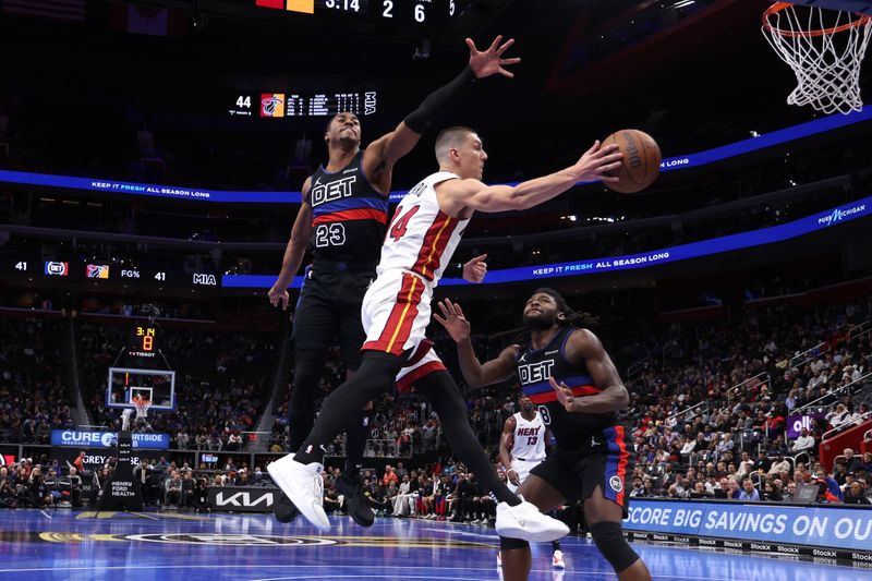 DETROIT, MICHIGAN - NOVEMBER 12: Tyler Herro #14 of the Miami Heat passes around Jaden Ivey #23 of the Detroit Pistons during the first half in the first round of the Emirates NBA Cup at Little Caesars Arena on November 12, 2024 in Detroit, Michigan. NOTE TO USER: User expressly acknowledges and agrees that, by downloading and or using this photograph, User is consenting to the terms and conditions of the Getty Images License. (Photo by Gregory Shamus/Getty Images)