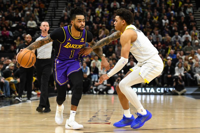 SALT LAKE CITY, UTAH - JANUARY 13: D'Angelo Russell #1 of the Los Angeles Lakers drives into Keyonte George #3 of the Utah Jazz during the second half of a game at Delta Center on January 13, 2024 in Salt Lake City, Utah. NOTE TO USER: User expressly acknowledges and agrees that, by downloading and or using this photograph, User is consenting to the terms and conditions of the Getty Images License Agreement. (Photo by Alex Goodlett/Getty Images)