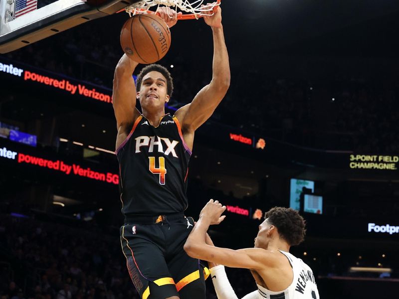 PHOENIX, ARIZONA - DECEMBER 03: Oso Ighodaro #4 of the Phoenix Suns dunks over Victor Wembanyama #1 of the San Antonio Spurs during the first half of the Emirates NBA Cup game at Footprint Center on December 03, 2024 in Phoenix, Arizona. NOTE TO USER: User expressly acknowledges and agrees that, by downloading and or using this photograph, User is consenting to the terms and conditions of the Getty Images License Agreement.  (Photo by Chris Coduto/Getty Images)