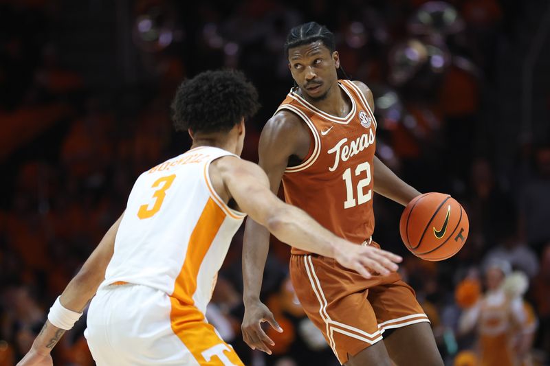 Jan 6, 2026; Knoxville, Tennessee, USA;  Texas Longhorns guard Tramon Mark (12) moves the ball against Tennessee Volunteers guard Bishop Boswell (3) during the second half at Thompson-Boling Arena at Food City Center. Mandatory Credit: Randy Sartin-Imagn Images