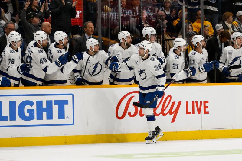 Nov 29, 2024; Nashville, Tennessee, USA;  Tampa Bay Lightning left wing Brandon Hagel (38) celebrates his goal with his teammates  against the Nashville Predators during the second period at Bridgestone Arena. Mandatory Credit: Steve Roberts-Imagn Images