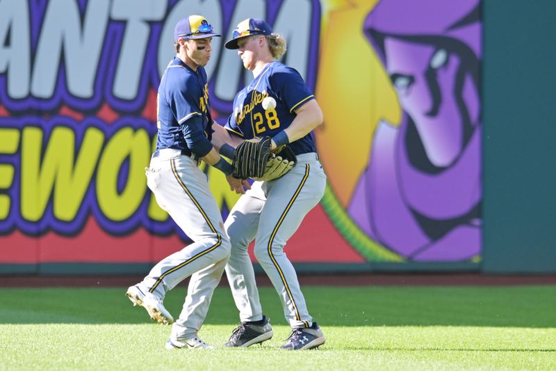 Jun 24, 2023; Cleveland, Ohio, USA; Milwaukee Brewers left fielder Christian Yelich (22) and center fielder Joey Wiemer (28) nearly collide while fielding an RBI hit by Cleveland Guardians second baseman Andres Gimenez (not pictured) during the eighth inning at Progressive Field. Mandatory Credit: Ken Blaze-USA TODAY Sports