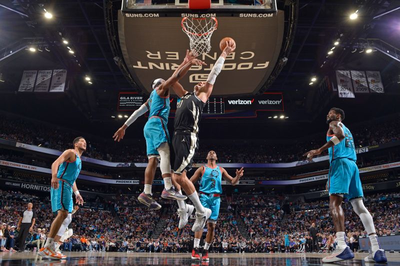 PHOENIX, AZ - MARCH 14: Brook Lopez #11 of the Milwaukee Bucks drives to the basket against the Phoenix Suns on March 14, 20223at Footprint Center in Phoenix, Arizona. NOTE TO USER: User expressly acknowledges and agrees that, by downloading and or using this photograph, user is consenting to the terms and conditions of the Getty Images License Agreement. Mandatory Copyright Notice: Copyright 2023 NBAE (Photo by Barry Gossage/NBAE via Getty Images)