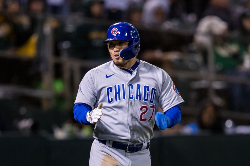 Apr 18, 2023; Oakland, California, USA; Chicago Cubs right fielder Seiya Suzuki (27) reacts after scoring against the Oakland Athletics during the eighth inning at RingCentral Coliseum. Mandatory Credit: John Hefti-USA TODAY Sports