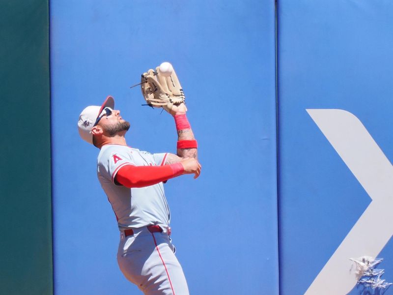 Jul 4, 2024; Oakland, California, USA; Los Angeles Angels center fielder Kevin Pillar (12) catches the ball against the Oakland Athletics during the fourth inning at Oakland-Alameda County Coliseum. Mandatory Credit: Kelley L Cox-USA TODAY Sports