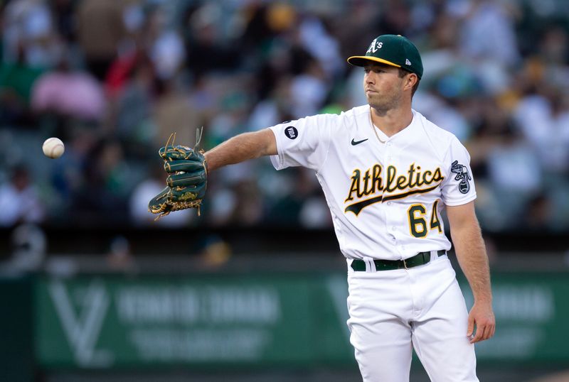 Aug 19, 2023; Oakland, California, USA; Oakland Athletics starting pitcher Ken Waldichuk (64) gets a new baseball during the fourth inning at Oakland-Alameda County Coliseum. Mandatory Credit: D. Ross Cameron-USA TODAY Sports