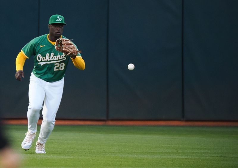 Sep 25, 2024; Oakland, California, USA; Oakland Athletics center fielder Daz Cameron (28) catches the ball against the Texas Rangers during the first inning at Oakland-Alameda County Coliseum. Mandatory Credit: Kelley L Cox-Imagn Images