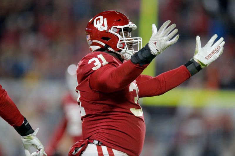 Nov 19, 2022; Norman, Oklahoma, USA; Oklahoma Sooners defensive lineman Jalen Redmond (31) celebrates after a sack against the Oklahoma State Cowboys at Gaylord Family-Oklahoma Memorial Stadiumat Gaylord Family-Oklahoma Memorial Stadium. Mandatory Credit: Bryan Terry-USA TODAY Sports