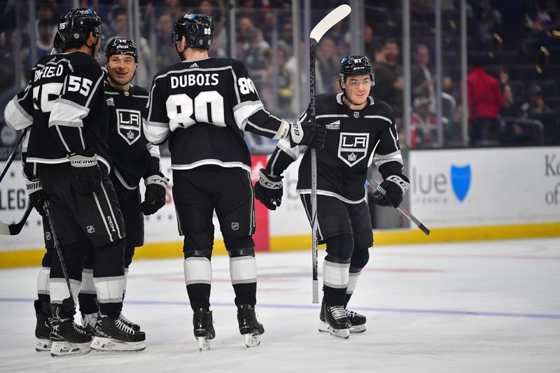 Mar 20, 2024; Los Angeles, California, USA; Los Angeles Kings defenseman Jordan Spence (21) celebrates his power play goal scored against the Minnesota Wild during the second period at Crypto.com Arena. Mandatory Credit: Gary A. Vasquez-USA TODAY Sports