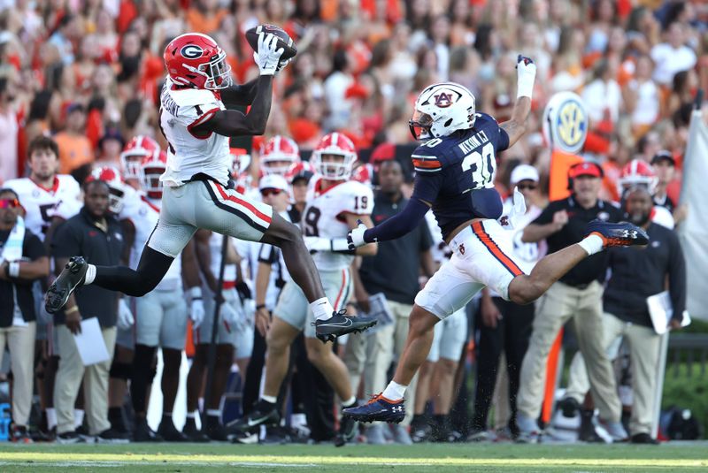 Sep 30, 2023; Auburn, Alabama, USA; Georgia Bulldogs wide receiver Marcus Rosemy-Jacksaint (1) makes a catch over Auburn Tigers linebacker Larry Nixon III (30) during the fourth quarter at Jordan-Hare Stadium. Mandatory Credit: John Reed-USA TODAY Sports