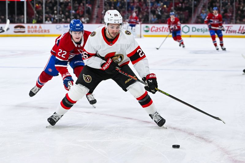 Jan 23, 2024; Montreal, Quebec, CAN; Ottawa Senators defenseman Erik Brannstrom (26) plays the puck against Montreal Canadiens right wing Cole Caufield (22) during the second period at Bell Centre. Mandatory Credit: David Kirouac-USA TODAY Sports