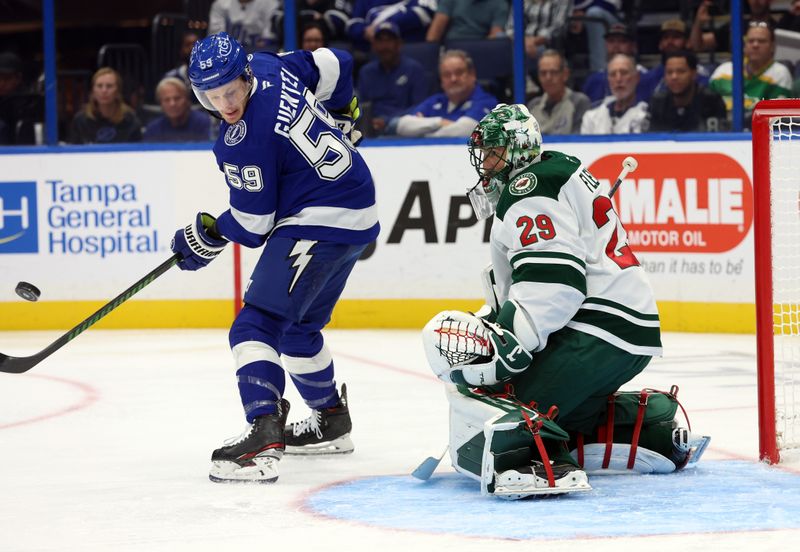 Oct 24, 2024; Tampa, Florida, USA; Tampa Bay Lightning center Jake Guentzel (59) and Minnesota Wild goaltender Marc-Andre Fleury (29) look at the puck and defend during the first period at Amalie Arena. Mandatory Credit: Kim Klement Neitzel-Imagn Images