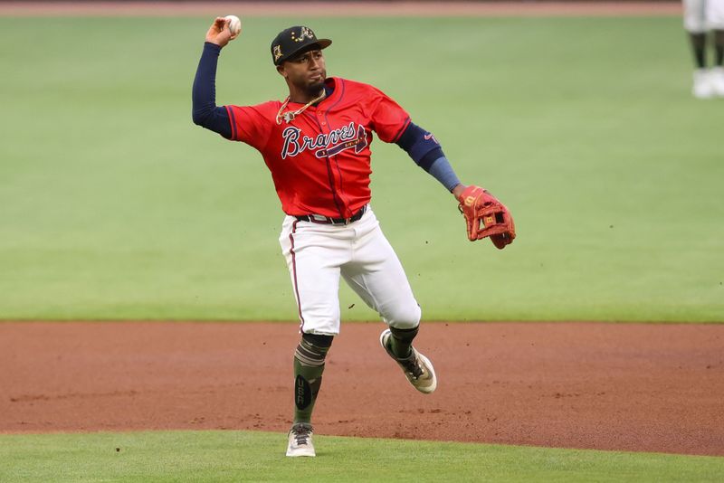 May 17, 2024; Atlanta, Georgia, USA; Atlanta Braves second baseman Ozzie Albies (1) throws a runner out at first against the San Diego Padres in the first inning at Truist Park. Mandatory Credit: Brett Davis-USA TODAY Sports
