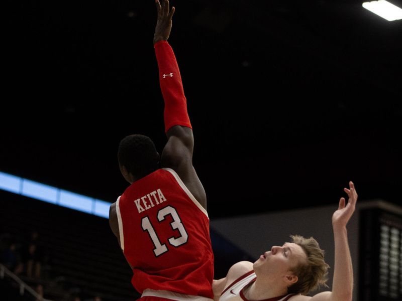 Jan 14, 2024; Stanford, California, USA; Stanford Cardinal guard Michael Jones (13) throws a shot up over Utah Utes center Keba Keita (13) during the second half at Maples Pavilion. Mandatory Credit: D. Ross Cameron-USA TODAY Sports