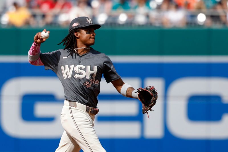 May 25, 2024; Washington, District of Columbia, USA; Washington Nationals shortstop CJ Abrams (5) makes a throw to first base on a ground ball by Seattle Mariners shortstop J.P. Crawford (not pictured) during the first inning at Nationals Park. Mandatory Credit: Geoff Burke-USA TODAY Sports