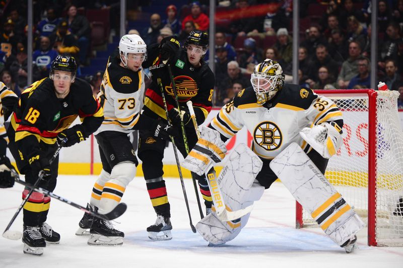 Feb 25, 2023; Vancouver, British Columbia, CAN; Boston Bruins goaltender Linus Ullmark (35) defends against Vancouver Canucks forward Jack Studnicka (18) and forward Nils Aman (88) during the third period at Rogers Arena. Mandatory Credit: Anne-Marie Sorvin-USA TODAY Sports