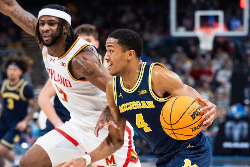 Mar 15, 2025; Indianapolis, IN, USA; Maryland Terrapins center Braden Pierce (4) dribbles the ball while Maryland Terrapins guard Selton Miguel (9) defends in the first half at Gainbridge Fieldhouse. Mandatory Credit: Trevor Ruszkowski-Imagn Images