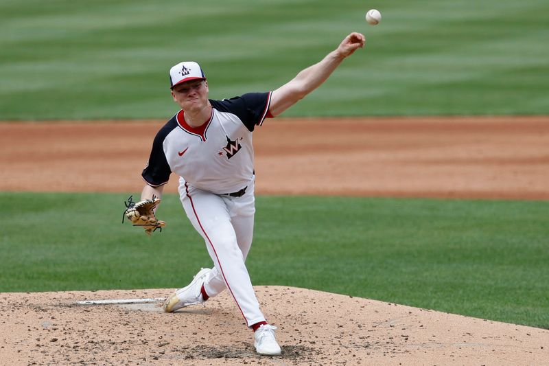 Jun 9, 2024; Washington, District of Columbia, USA; Washington Nationals starting pitcher DJ Herz (74) pitches against the Atlanta Braves during the third inning at Nationals Park. Mandatory Credit: Geoff Burke-USA TODAY Sports