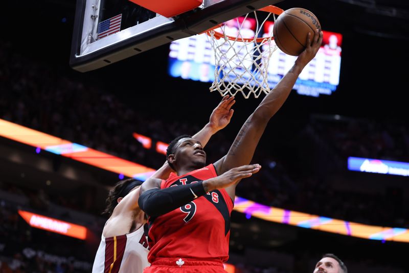 MIAMI, FLORIDA - APRIL 12: RJ Barrett #9 of the Toronto Raptors shoots the ball past Jaime Jaquez Jr. #11 of the Miami Heat during the fourth quarter of the game at Kaseya Center on April 12, 2024 in Miami, Florida. NOTE TO USER: User expressly acknowledges and agrees that, by downloading and or using this photograph, User is consenting to the terms and conditions of the Getty Images License Agreement. (Photo by Megan Briggs/Getty Images)