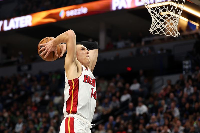 MINNEAPOLIS, MINNESOTA - NOVEMBER 10: Tyler Herro #14 of the Miami Heat dunks the ball against the Minnesota Timberwolves in the third quarter at Target Center on November 10, 2024 in Minneapolis, Minnesota. The Heat defeated the Timberwolves 95-94. NOTE TO USER: User expressly acknowledges and agrees that, by downloading and or using this photograph, User is consenting to the terms and conditions of the Getty Images License Agreement. (Photo by David Berding/Getty Images)