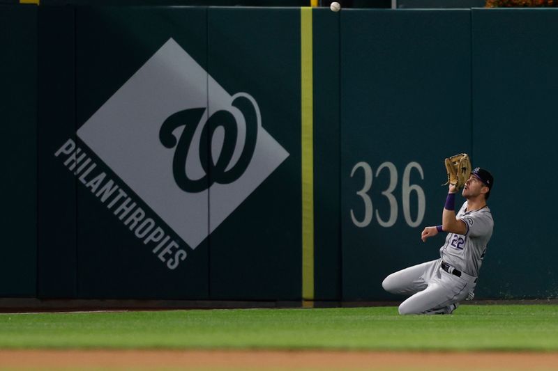 Aug 20, 2024; Washington, District of Columbia, USA; Colorado Rockies outfielder Nolan Jones (22) slides to make a catch on a fly ball hit by Washington Nationals third baseman Andrés Chaparro (not pictured) to end the eighth inning at Nationals Park. Mandatory Credit: Geoff Burke-USA TODAY Sports