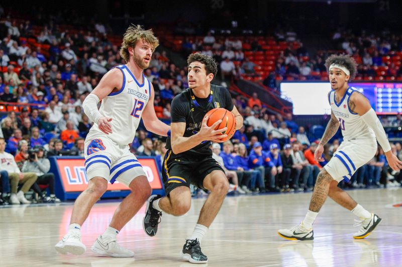 Feb 20, 2024; Boise, Idaho, USA; San Jose State Spartans guard Alvaro Cardenas (13) works against Boise State Broncos guard Max Rice (12) during the first half at  ExtraMile Arena. Mandatory Credit: Brian Losness-USA TODAY Sports