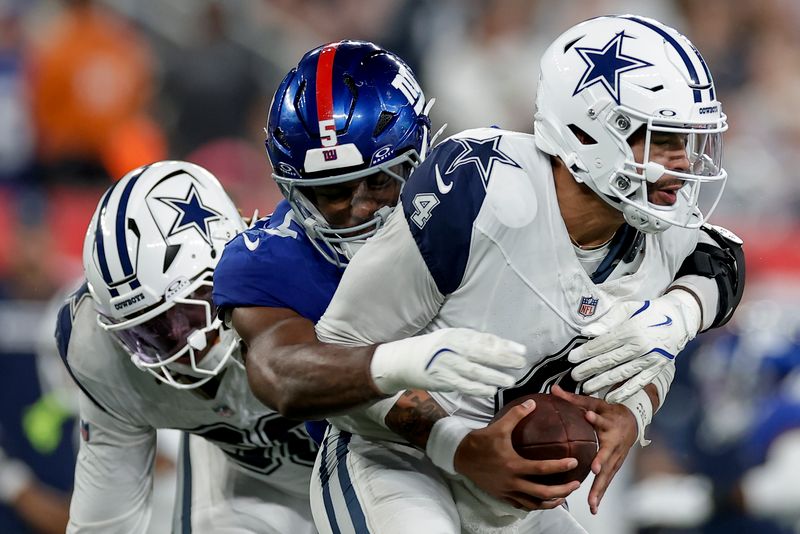 New York Giants linebacker Kayvon Thibodeaux (5) sacks Dallas Cowboys quarterback Dak Prescott (4) during the second quarter of an NFL football game, Thursday, Sept. 26, 2024, in East Rutherford, N.J. (AP Photo/Adam Hunger)