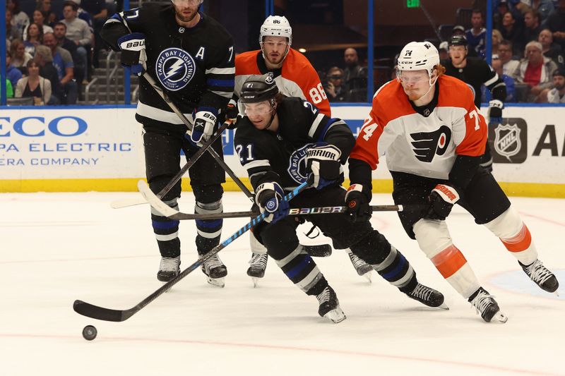 Mar 9, 2024; Tampa, Florida, USA; Tampa Bay Lightning center Brayden Point (21) skates with the puck as Philadelphia Flyers right wing Owen Tippett (74) defends during the second period at Amalie Arena. Mandatory Credit: Kim Klement Neitzel-USA TODAY Sports