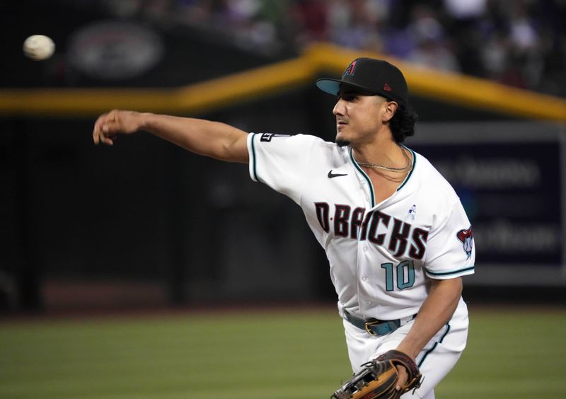 Jun 18, 2023; Phoenix, Arizona, USA; Arizona Diamondbacks relief pitcher Josh Rojas (10) throws against the Cleveland Guardians during the ninth inning at Chase Field. Mandatory Credit: Joe Camporeale-USA TODAY Sports