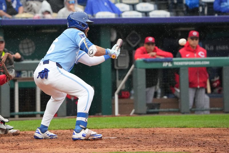 May 26, 2025; Kansas City, Missouri, USA; Kansas City Royals right fielder John Rave (26) bunts the ball against the Cincinnati Reds in the seventh inning at Kauffman Stadium. Mandatory Credit: Denny Medley-Imagn Images