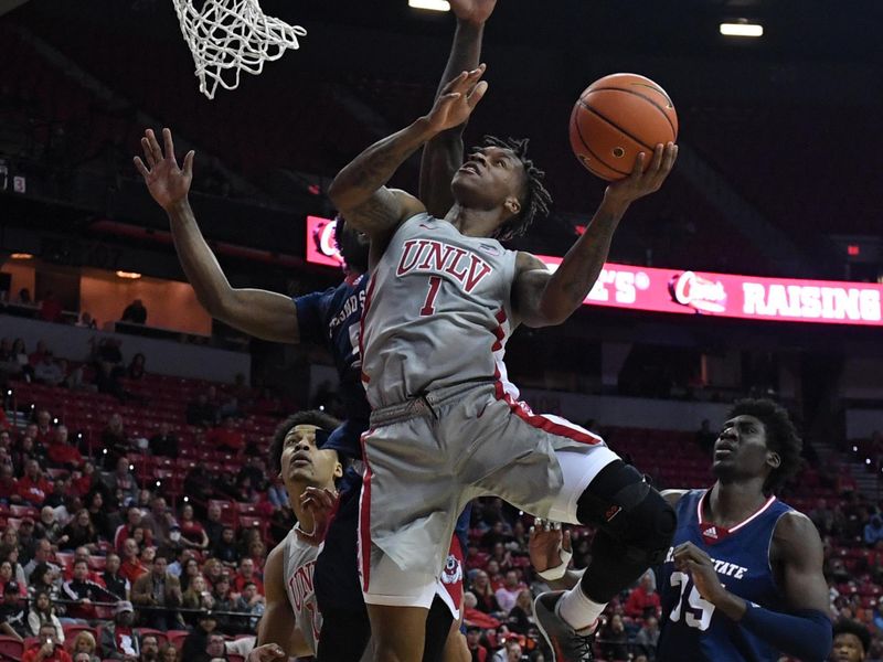 Feb 3, 2023; Las Vegas, Nevada, USA; UNLV Runnin' Rebels guard Elijah Parquet (1) scores on Fresno State Bulldogs guard Jordan Campbell (5) in the first half at Thomas & Mack Center. Mandatory Credit: Candice Ward-USA TODAY Sports