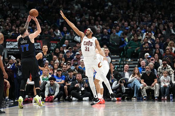 DALLAS, TX - DECEMBER 27: Luka Doncic #77 of the Dallas Mavericks shoots the ball while Jarrett Allen #31 of the Cleveland Cavaliers goes for the block during the game on December 27, 2023 at the American Airlines Center in Dallas, Texas. NOTE TO USER: User expressly acknowledges and agrees that, by downloading and or using this photograph, User is consenting to the terms and conditions of the Getty Images License Agreement. Mandatory Copyright Notice: Copyright 2023 NBAE (Photo by Glenn James/NBAE via Getty Images)