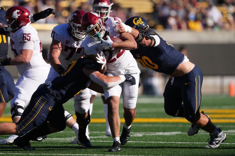 Nov 11, 2023; Berkeley, California, USA; Washington State Cougars running back Leo Pulalasi (22) is tackled by California Golden Bears linebacker Cade Uluave (left) and defensive lineman Brett Johnson (right) during the second quarter at California Memorial Stadium. Mandatory Credit: Darren Yamashita-USA TODAY Sports 