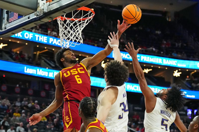 Mar 13, 2024; Las Vegas, NV, USA; USC Trojans guard Bronny James (6) deflects a rebound away from Washington Huskies center Braxton Meah (34) and guard Sahvir Wheeler (5) during the first half at T-Mobile Arena. Mandatory Credit: Stephen R. Sylvanie-USA TODAY Sports