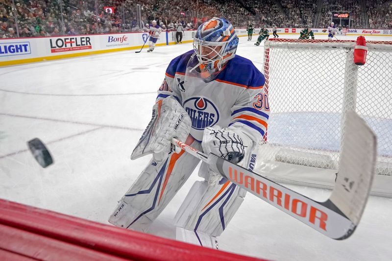 Jan 15, 2025; Saint Paul, Minnesota, USA;  Edmonton Oilers goaile Calvin Pickard (30) attempts to stop a puck against the Minnesota Wild during the first period at Xcel Energy Center. Mandatory Credit: Nick Wosika-Imagn Images

