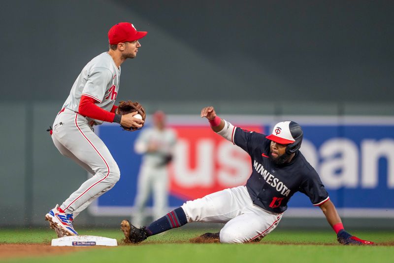 Jul 22, 2024; Minneapolis, Minnesota, USA; Philadelphia Phillies shortstop Trea Turner (7) forces out Minnesota Twins left fielder Manuel Margot (13) at second base for an out in the third inning at Target Field. Mandatory Credit: Jesse Johnson-USA TODAY Sports